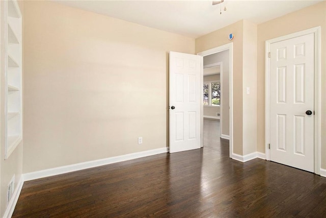 1207 Ellington Dr, Morrow, GA 30260 - unfurnished bedroom with dark wood finished floors, baseboards, and a ceiling fan