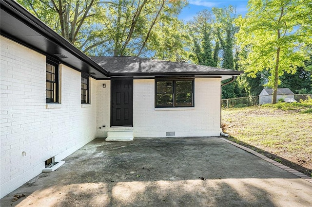 1207 Ellington Dr, Morrow, GA 30260 - property entrance with crawl space, brick siding, a patio, and roof with shingles