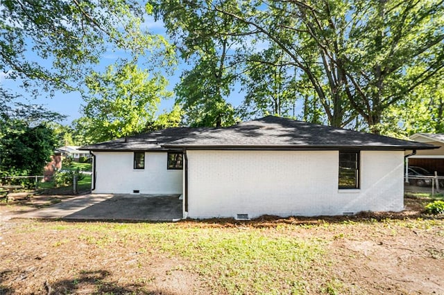 1207 Ellington Dr, Morrow, GA 30260 - view of side of home with crawl space, brick siding, and a patio