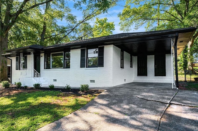 1207 Ellington Dr, Morrow, GA 30260 - view of front facade featuring crawl space, brick siding, driveway, an attached carport, and a front lawn