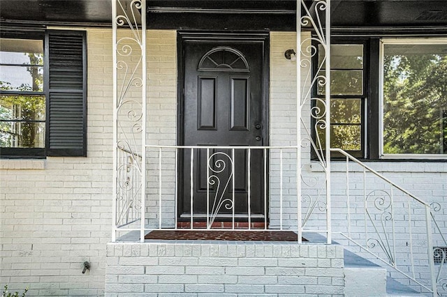 1207 Ellington Dr, Morrow, GA 30260 - doorway to property featuring brick siding and a porch