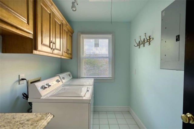 laundry room with washing machine and clothes dryer, cabinet space, electric panel, baseboards, and light tile patterned floors