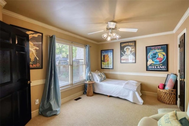 bedroom with carpet, baseboards, crown molding, and a ceiling fan