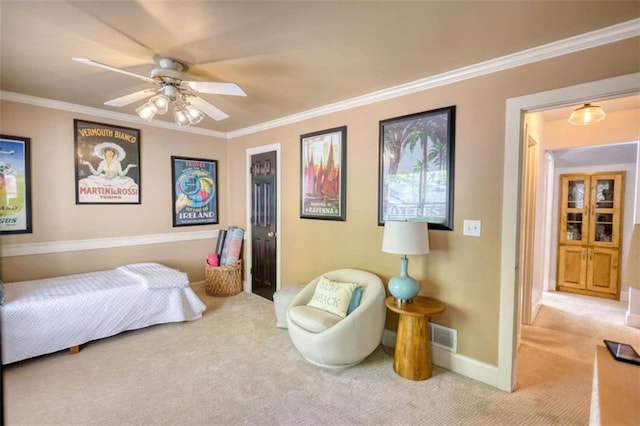 carpeted bedroom with crown molding, baseboards, and a ceiling fan