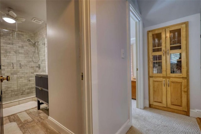 full bathroom featuring a stall shower, baseboards, and a ceiling fan
