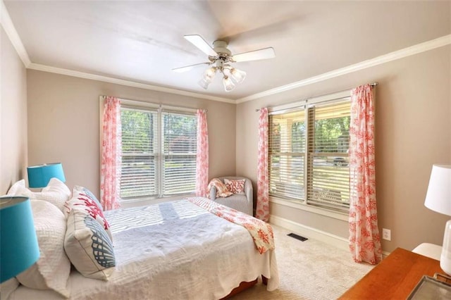 bedroom featuring carpet, crown molding, baseboards, and a ceiling fan