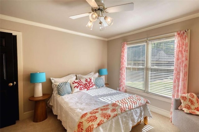 bedroom featuring carpet, baseboards, crown molding, and a ceiling fan