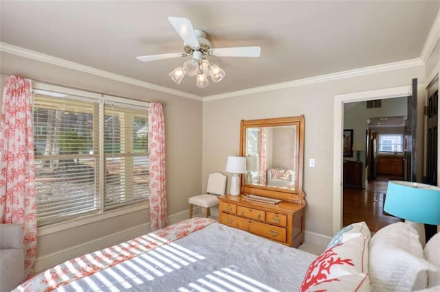 bedroom featuring crown molding, baseboards, and a ceiling fan