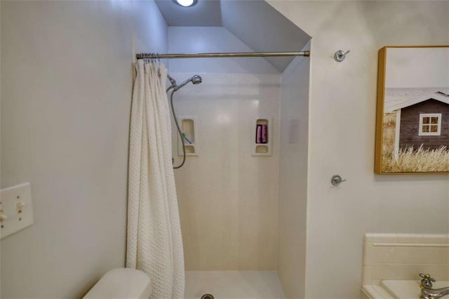 full bath featuring a stall shower and toilet