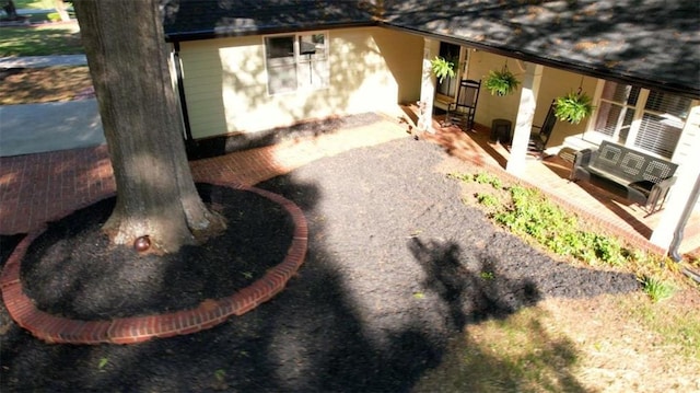 view of home's exterior featuring stucco siding, roof with shingles, and a patio area