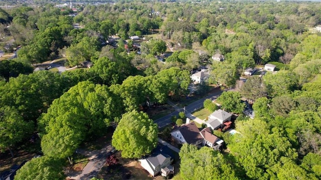 view of property location with a forest