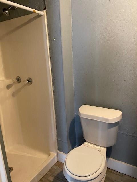 bathroom with a shower and toilet