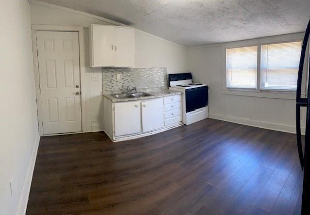 kitchen with white range with electric cooktop, white cabinets, lofted ceiling, and sink