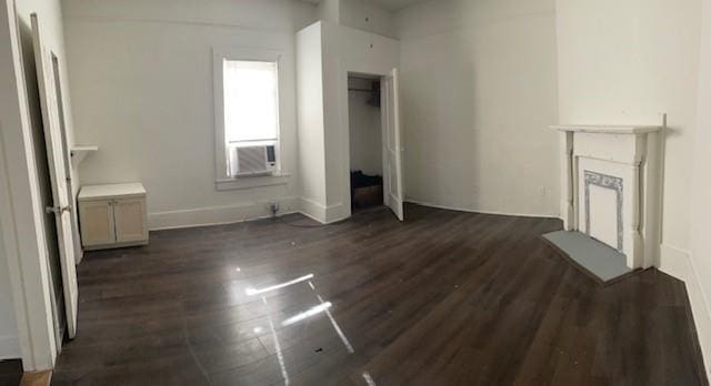 unfurnished living room with dark hardwood / wood-style flooring and cooling unit