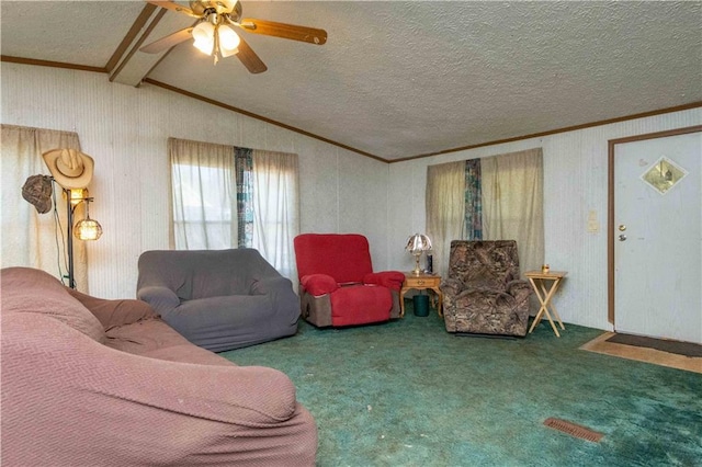 living room with carpet floors, lofted ceiling with beams, ceiling fan, crown molding, and a textured ceiling