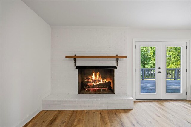 details with a fireplace, hardwood / wood-style flooring, and french doors