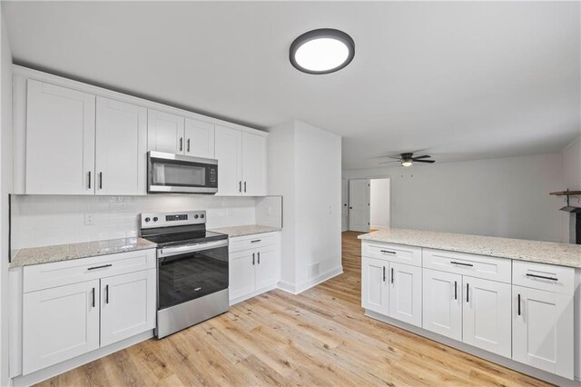 kitchen featuring ceiling fan, light hardwood / wood-style flooring, stainless steel appliances, and white cabinets