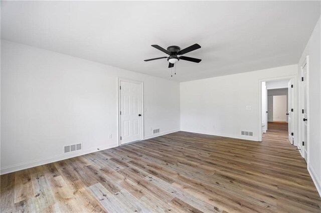 unfurnished room with ceiling fan and hardwood / wood-style floors