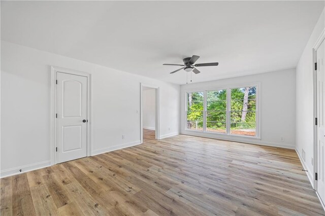 spare room with ceiling fan and light wood-type flooring