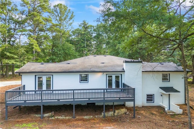 rear view of property featuring a deck and french doors