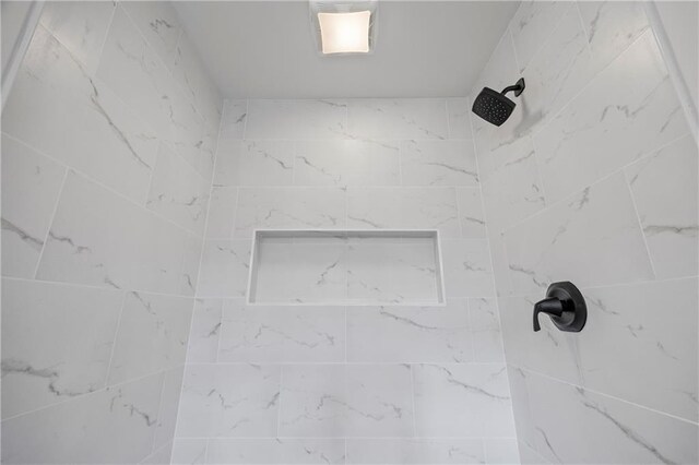 room details featuring a tile shower