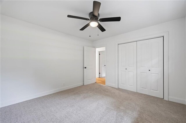 unfurnished bedroom with light carpet, a closet, and ceiling fan