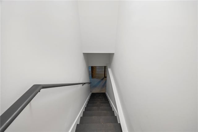 stairs with dark tile patterned floors