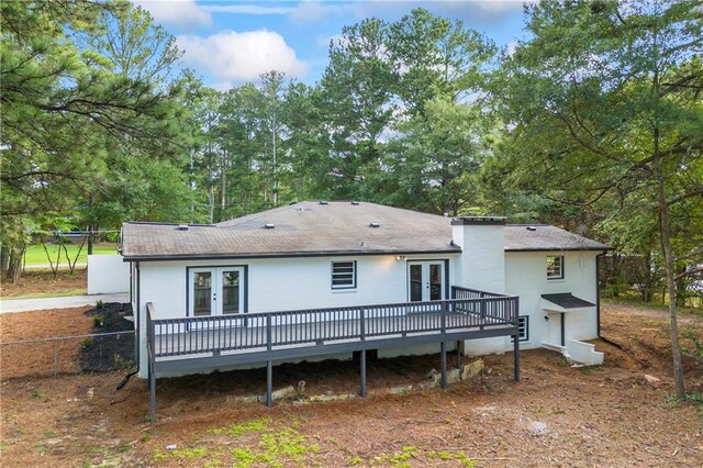 rear view of property featuring a deck