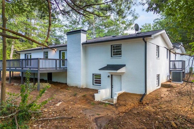 rear view of house with a deck and central AC