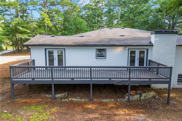 exterior space with a deck and french doors