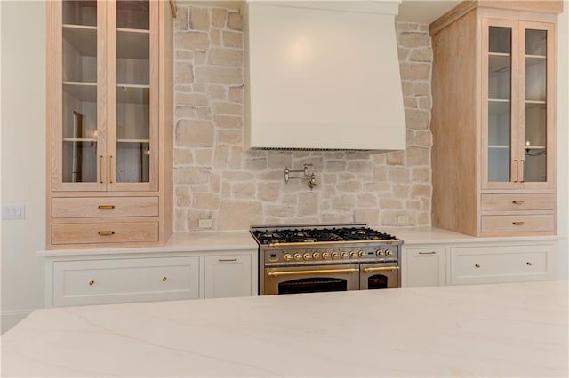 789 Old Mill Ct, Ball Ground, GA 30107 - kitchen with double oven range, light stone countertops, glass insert cabinets, and decorative backsplash