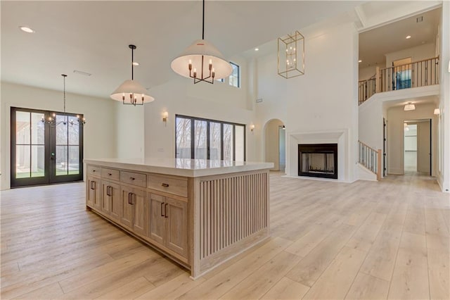 789 Old Mill Ct, Ball Ground, GA 30107 - kitchen featuring a chandelier, light wood-style floors, light countertops, a towering ceiling, and recessed lighting