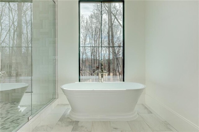 789 Old Mill Ct, Ball Ground, GA 30107 - full bathroom featuring marble finish floors, a soaking tub, tiled shower, and baseboards