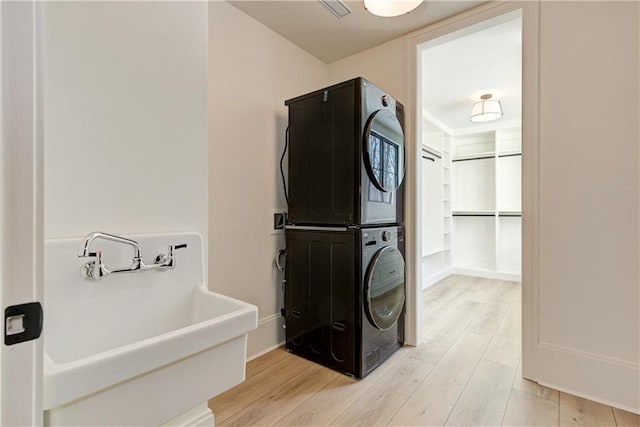 789 Old Mill Ct, Ball Ground, GA 30107 - bathroom with stacked washer / drying machine, wood finished floors, and a sink
