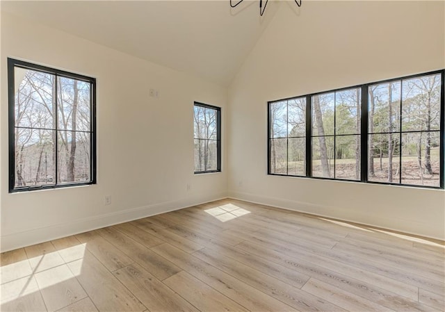 789 Old Mill Ct, Ball Ground, GA 30107 - spare room with light wood-style floors, baseboards, and high vaulted ceiling