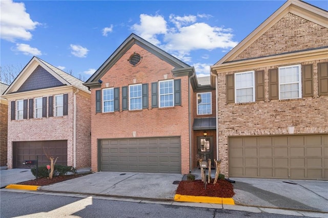 townhome / multi-family property featuring concrete driveway, brick siding, and a garage