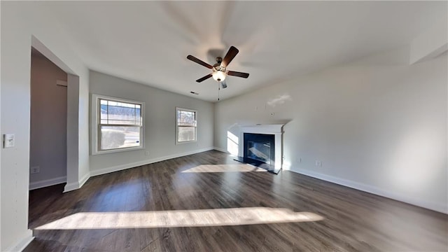 unfurnished living room with dark hardwood / wood-style floors and ceiling fan