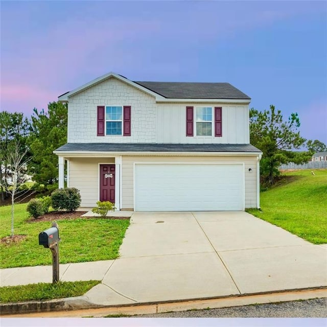 view of property with a yard and a garage