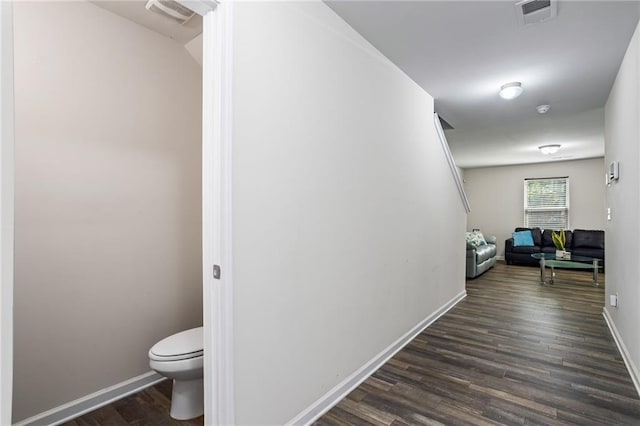 corridor featuring dark hardwood / wood-style flooring