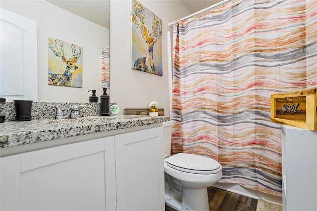 bathroom featuring hardwood / wood-style flooring, vanity, and toilet