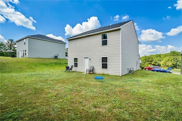 back of property featuring a lawn