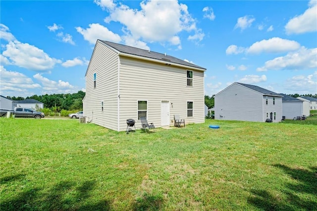 back of house with a lawn