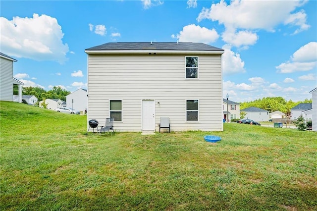 back of house featuring a lawn