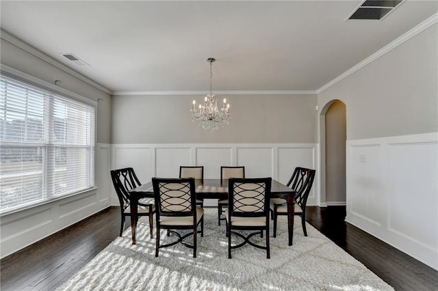 dining area with a chandelier, dark hardwood / wood-style flooring, plenty of natural light, and crown molding