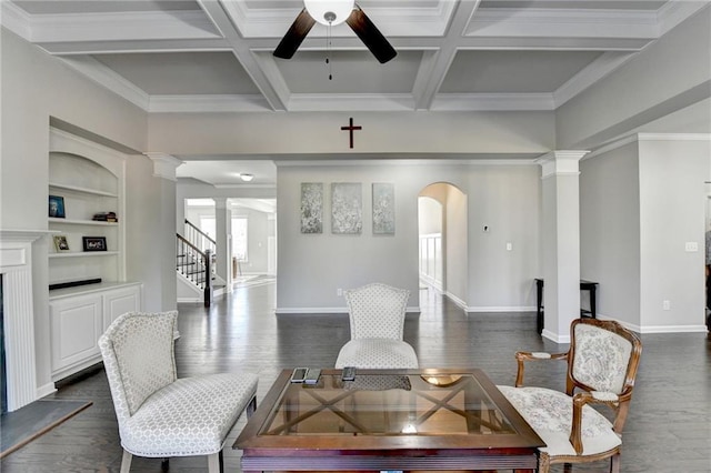 living room featuring coffered ceiling, ceiling fan, dark hardwood / wood-style floors, built in features, and beam ceiling