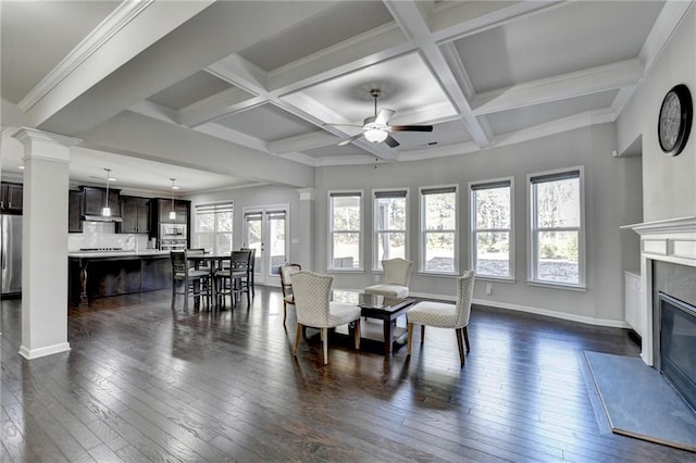 dining space featuring a premium fireplace, dark hardwood / wood-style flooring, ceiling fan, and coffered ceiling