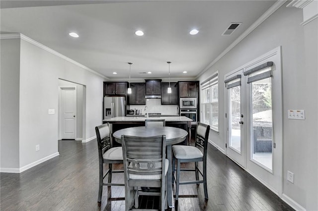 dining space with crown molding, french doors, dark wood-type flooring, and sink