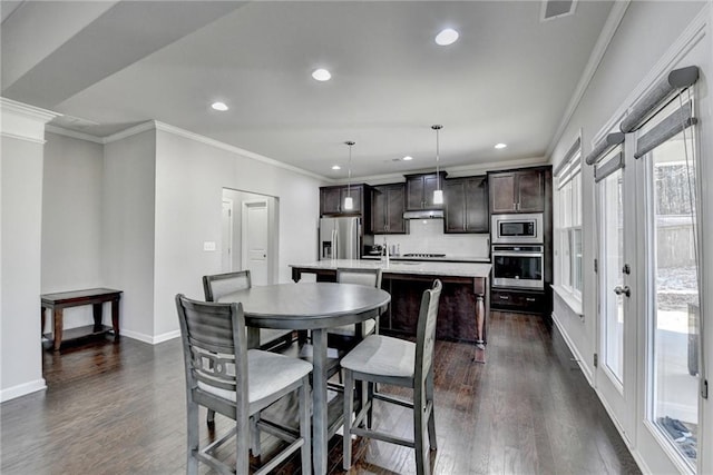 dining room featuring dark hardwood / wood-style floors and ornamental molding