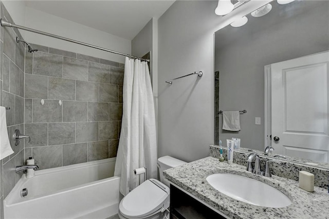 full bathroom featuring shower / bath combo, vanity, and toilet