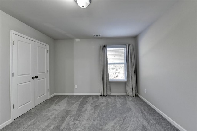 unfurnished room with light carpet